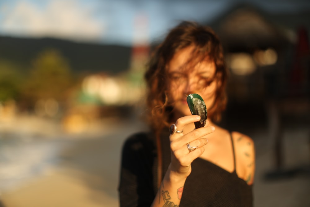 shallow focus photo of woman holding mussel