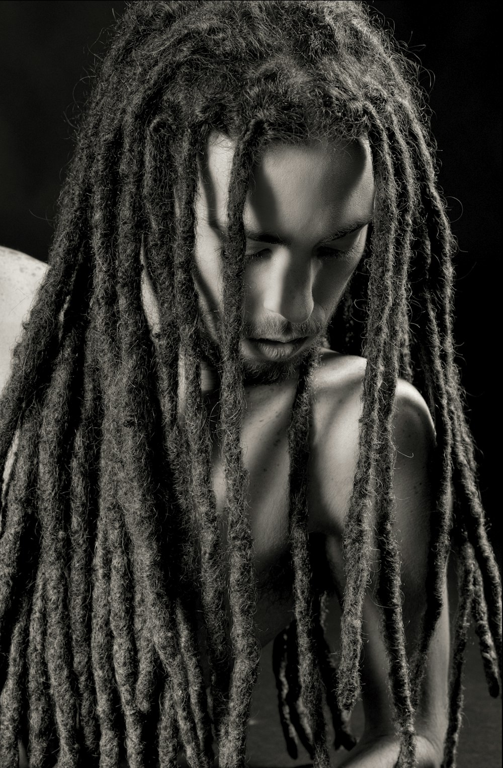 gray scale photo of man with dreadlock hairstyle