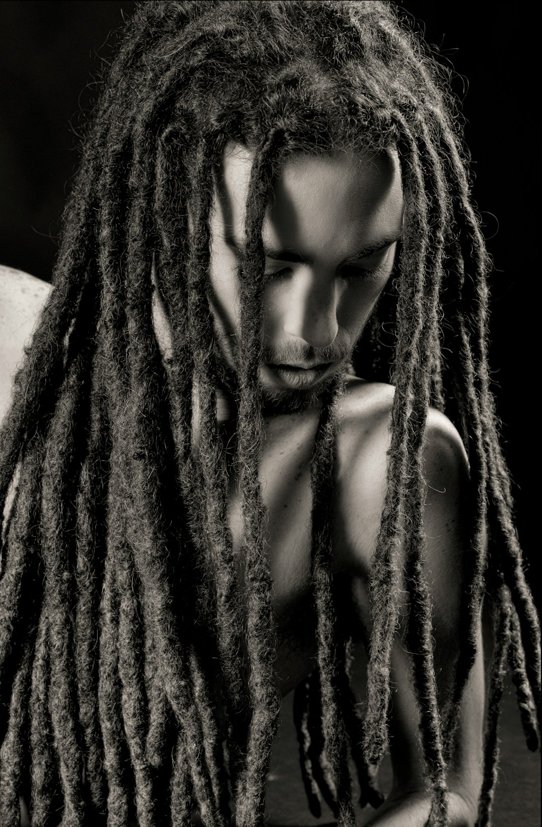 gray scale photo of man with dreadlock hairstyle