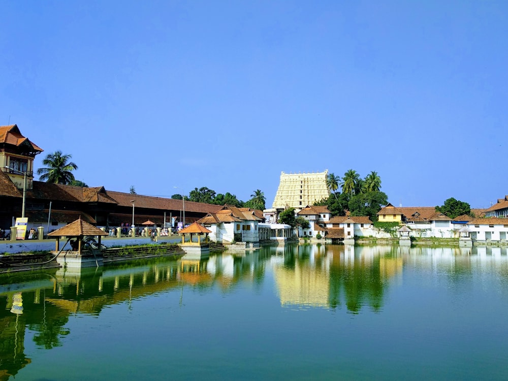 brown-and-white concrete building near body of water during daytime