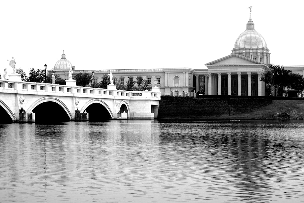 grayscale photo of building near body of water during daytime