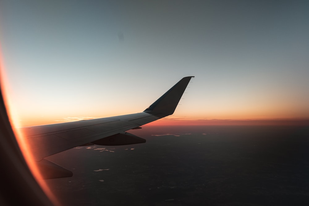 gray airplane flying during daytime