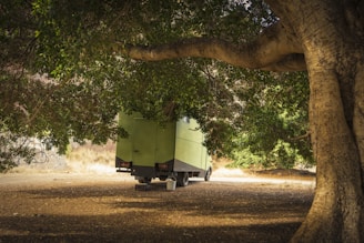 Electric vehicle parked under intense sunlight showing heat stress on battery.