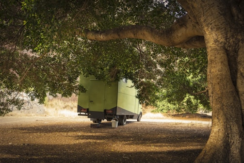 Electric vehicle parked under intense sunlight showing heat stress on battery.