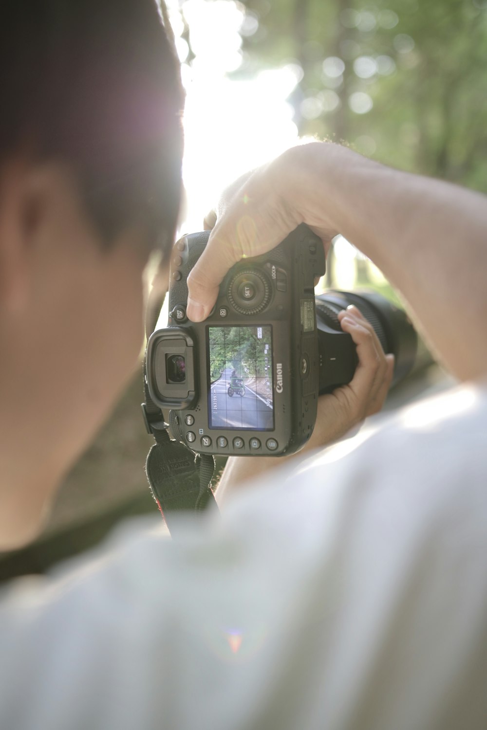 person holding DSLR camera