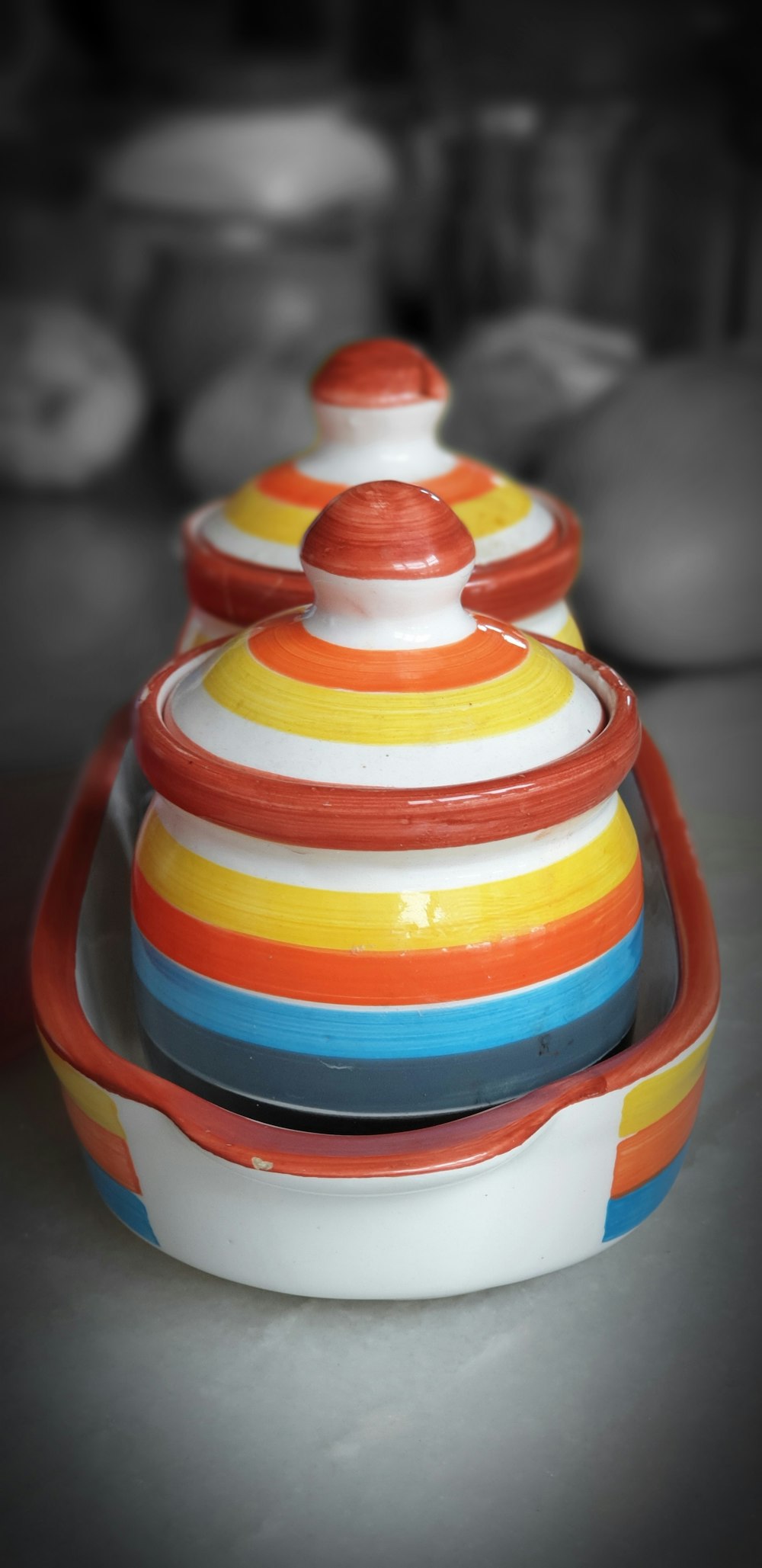 two multicolored ceramic canisters