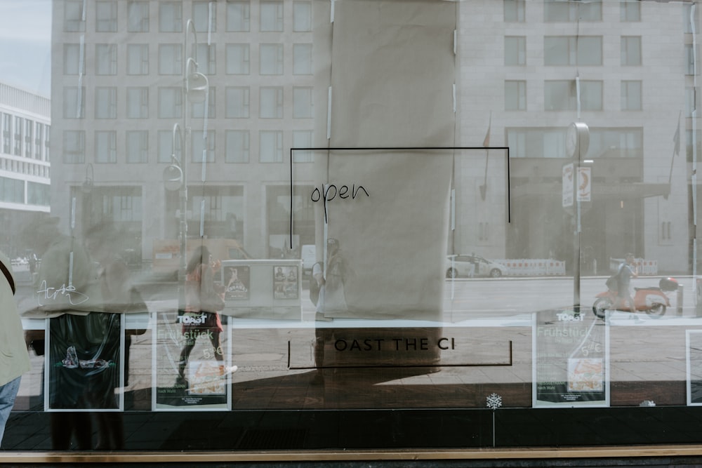 a woman standing in front of a store window