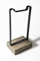 A sturdy writing desk made of metal with clean lines and a natural wood top.