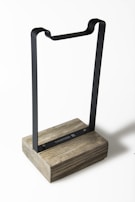 Sleek contemporary decorative object combining metal and wood, inspired by global travels.