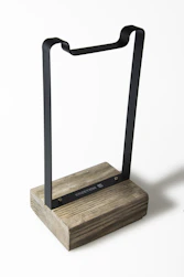 Close-up of a minimalist walnut plant stand showcasing smooth grain and hand-finished edges.