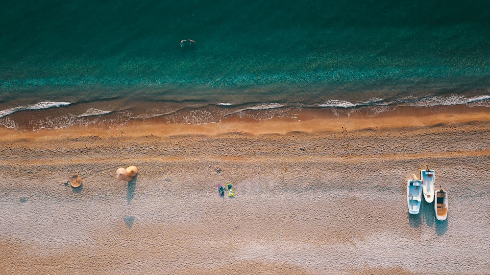 aerial photography of three boats parked on shore