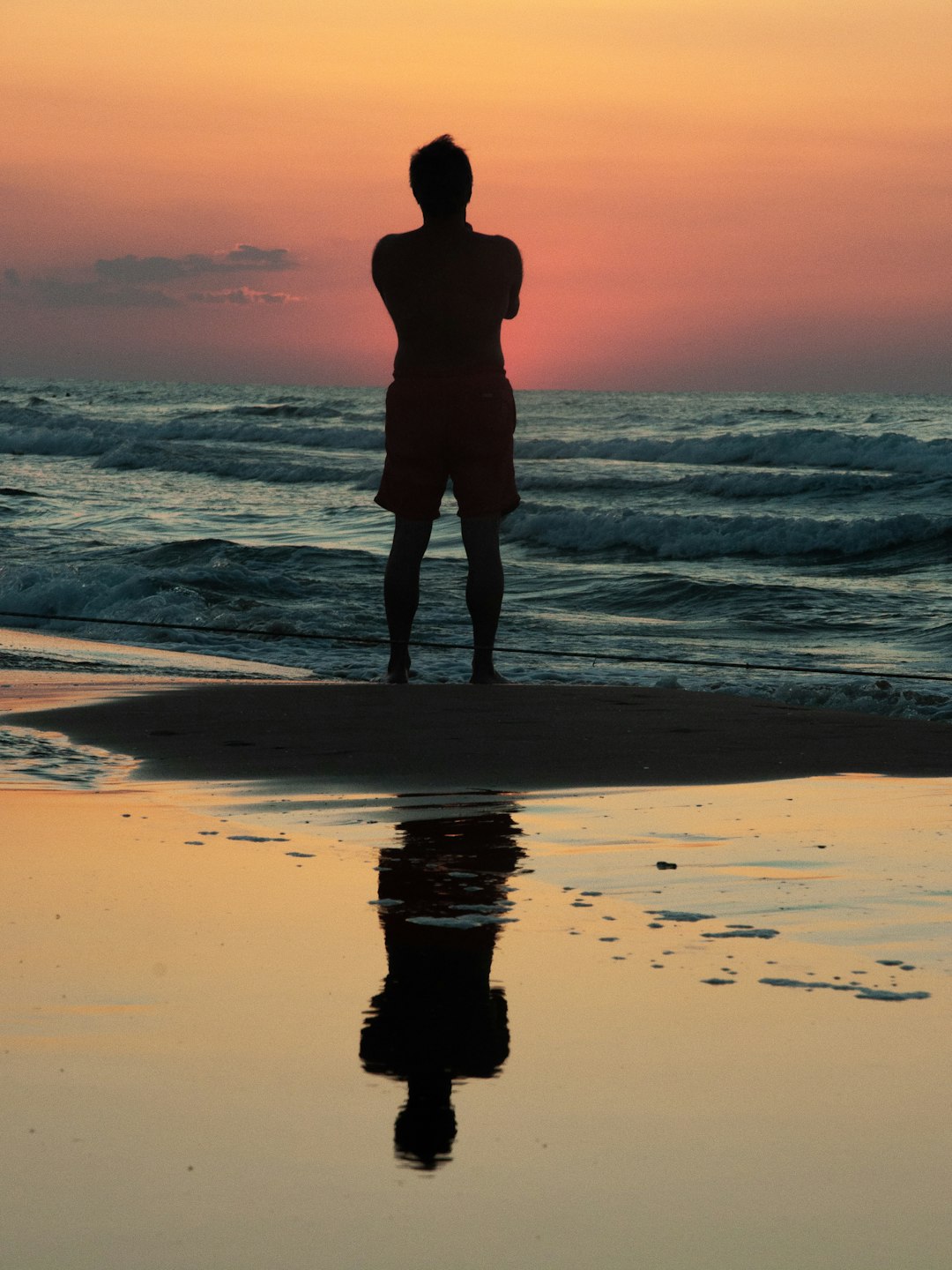 topless person standing near seashore