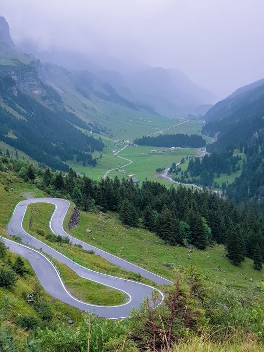 spiral road near green field and mountain view in Klausen Pass Switzerland