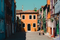 Sunlit street view of colorful houses in a vibrant Orlando neighborhood.