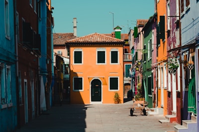 Sunlit street view of colorful houses in a vibrant Orlando neighborhood.