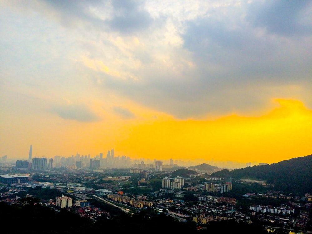 city with high-rise buildings under blue and yellow skies