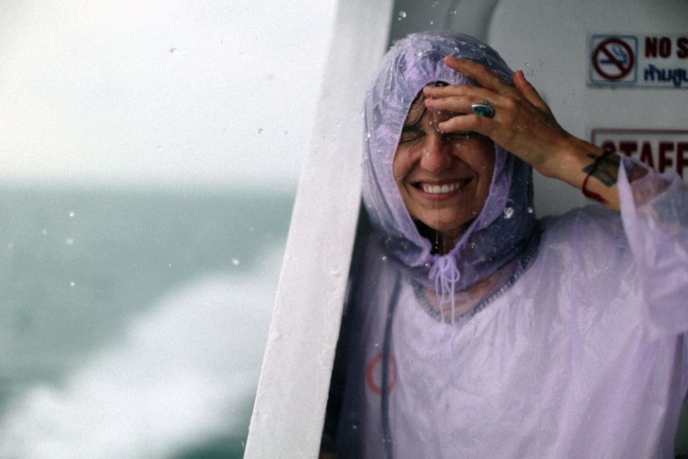 woman wears purple raincoat got wet