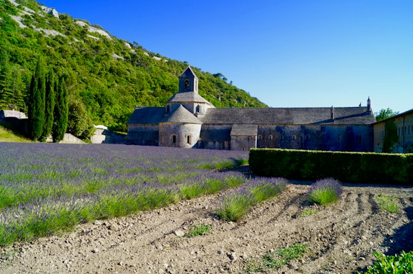 Grey church building in foot of hill — Provence, France