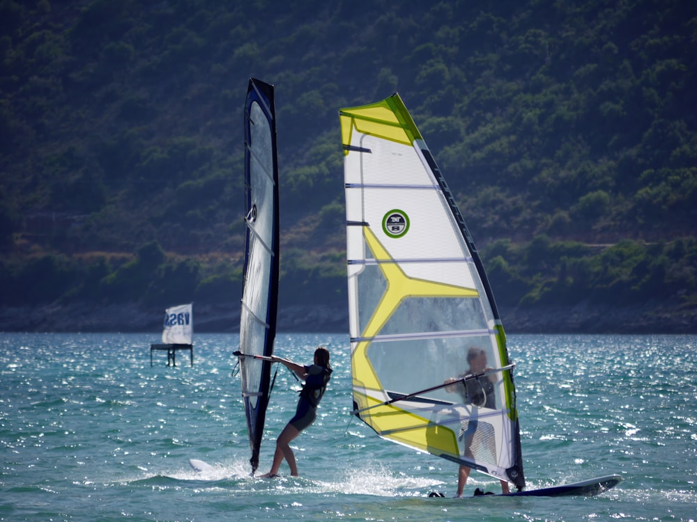 two person doing water sports during daytime