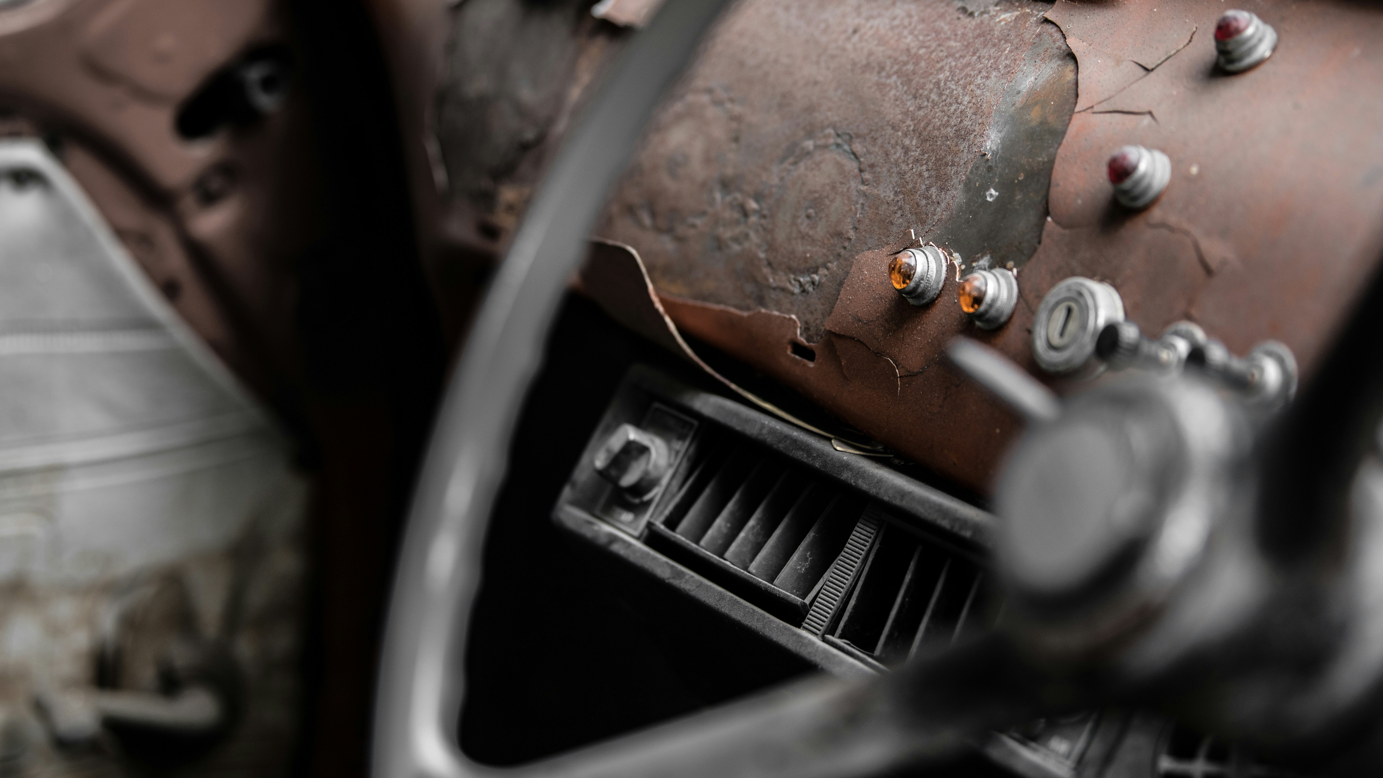 Light buttons are in the old car with dirty and rustic condition.