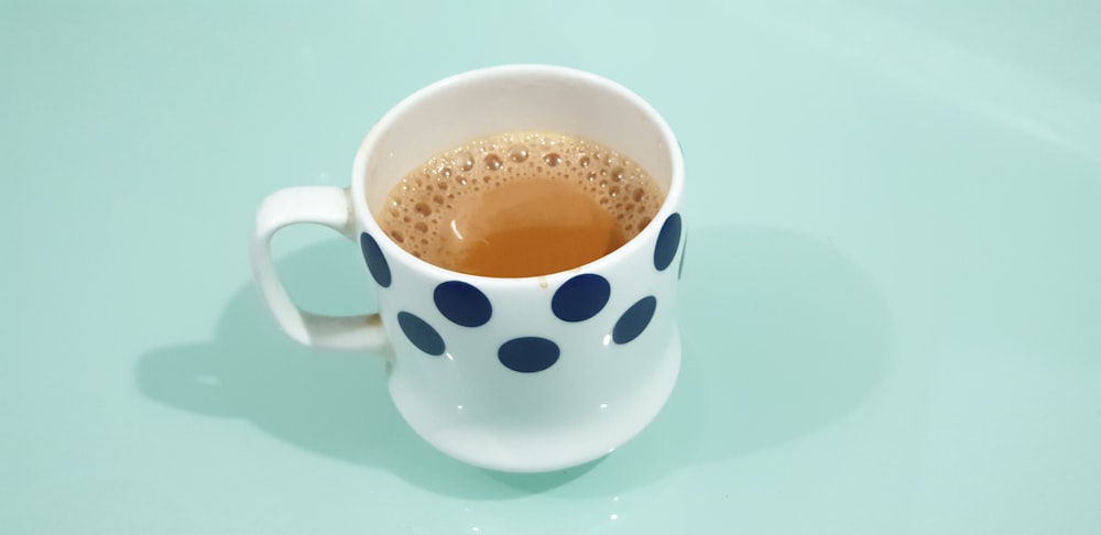 white and blue polka-dot ceramic mug