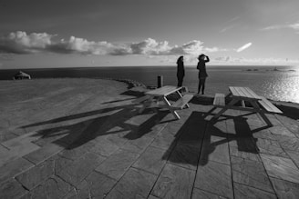 two women standing near ocean