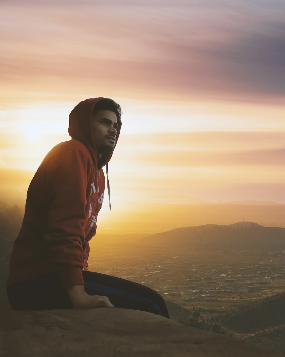 man wearing red pullover hoodie