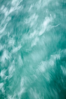 Blurred motion of turquoise water creating a dynamic and flowing pattern.