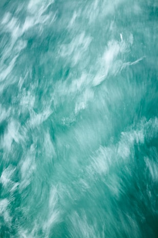 Blurred motion of turquoise water creating a dynamic and flowing pattern.