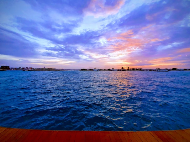 Ocean view from the cliffside room balcony at sunset with vibrant colors.