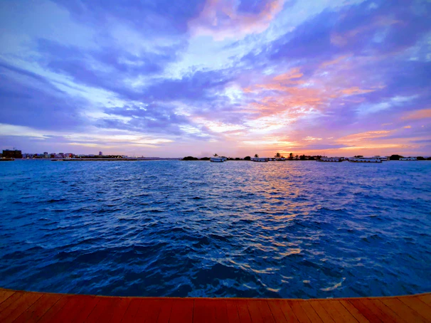 Sunset view from a hotel balcony with amber and navy hues in the sky.