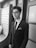 A well-dressed man in a stylish blazer standing confidently.