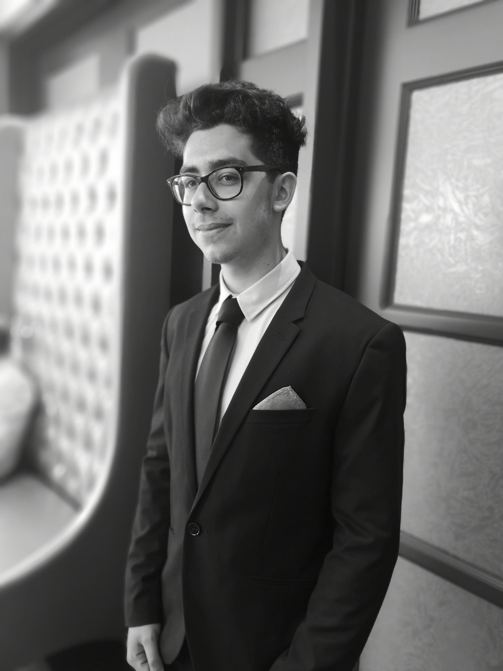 man in peaked lapel blazer standing in room