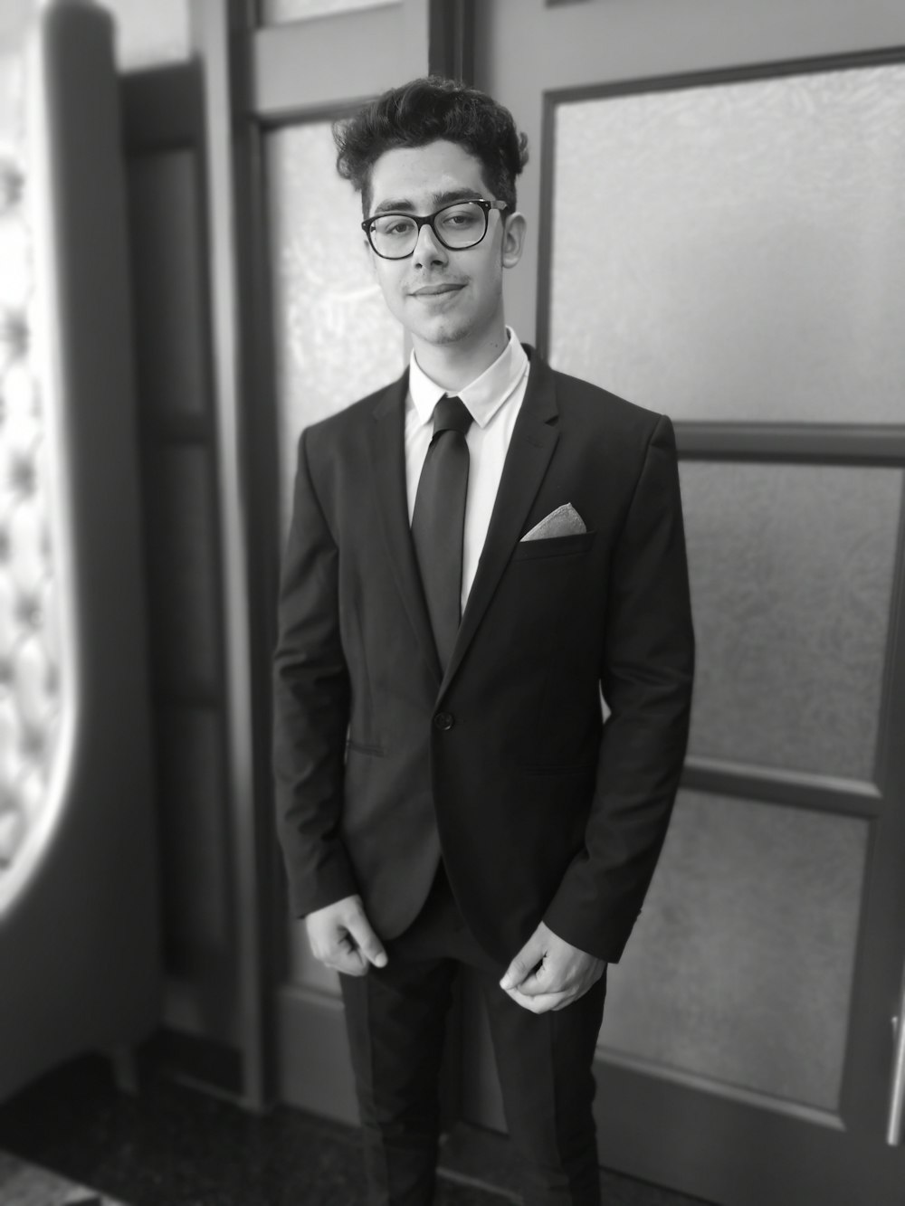 grayscale photography of man wearing eyeglasses