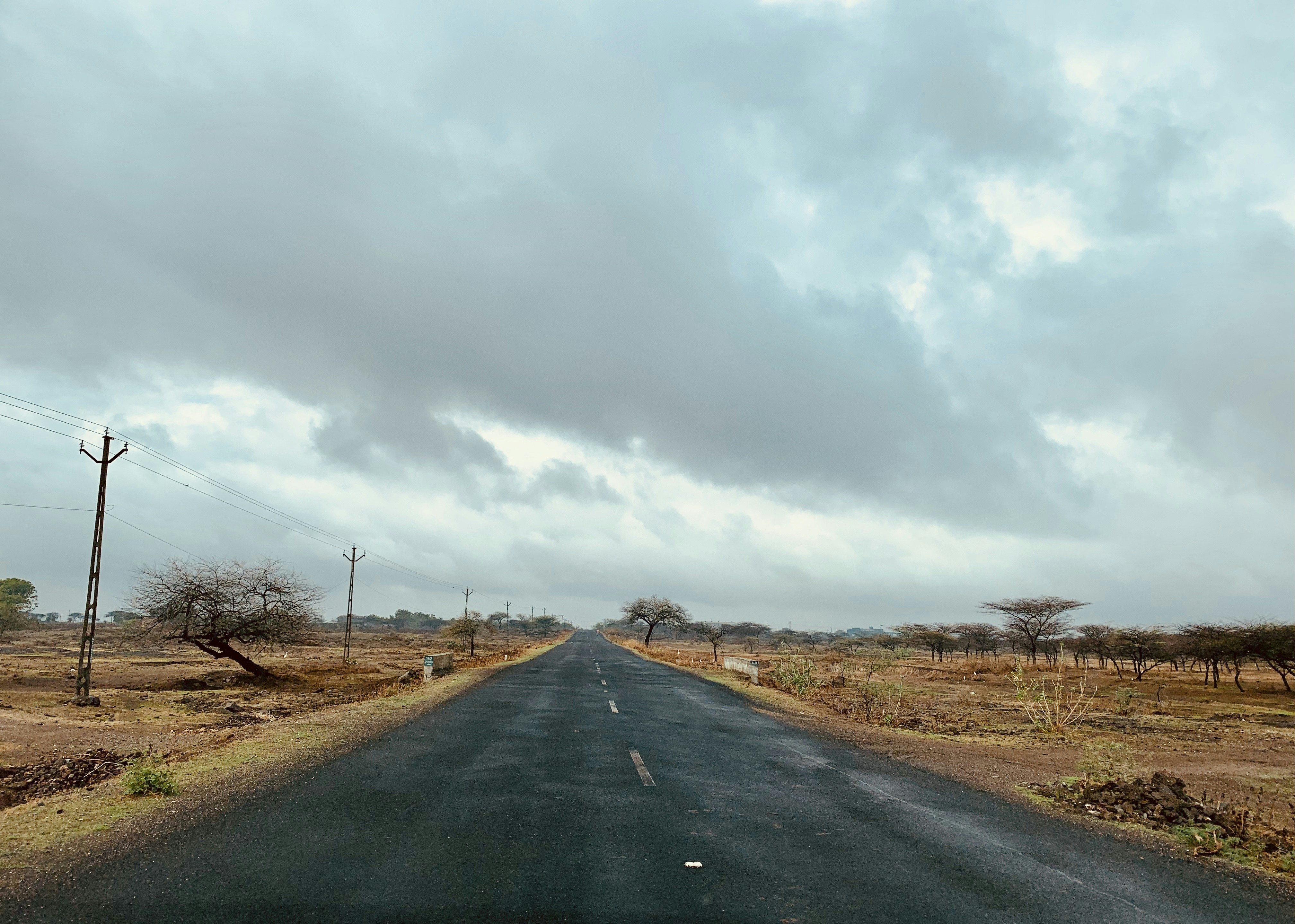 black asphalt road under cloudy sky during daytime