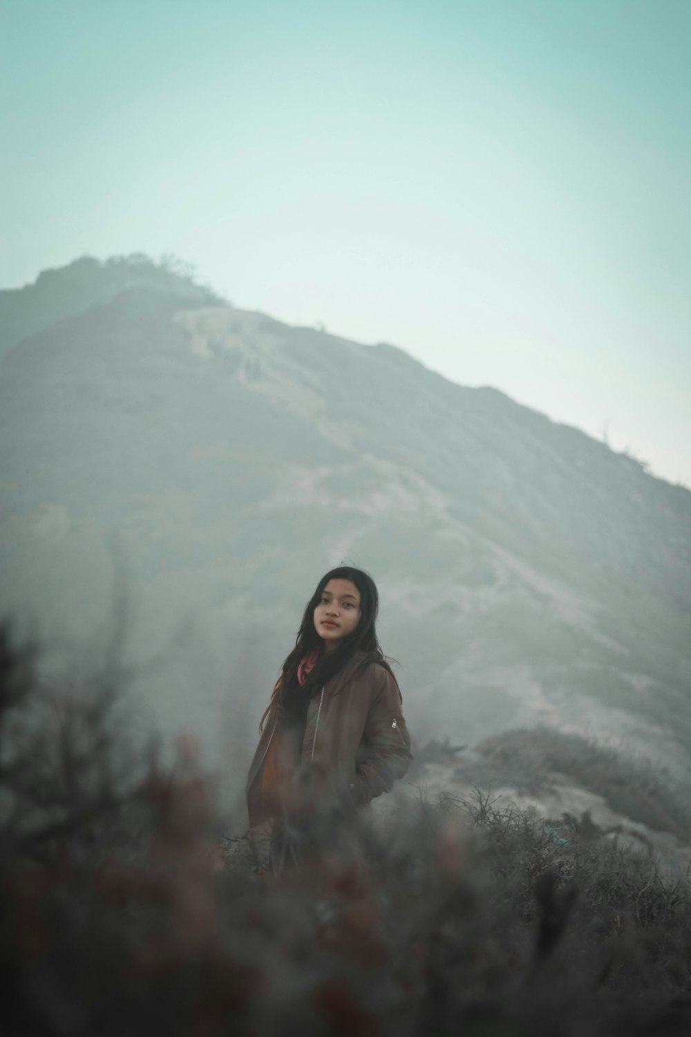 woman wearing jacket near mountainss