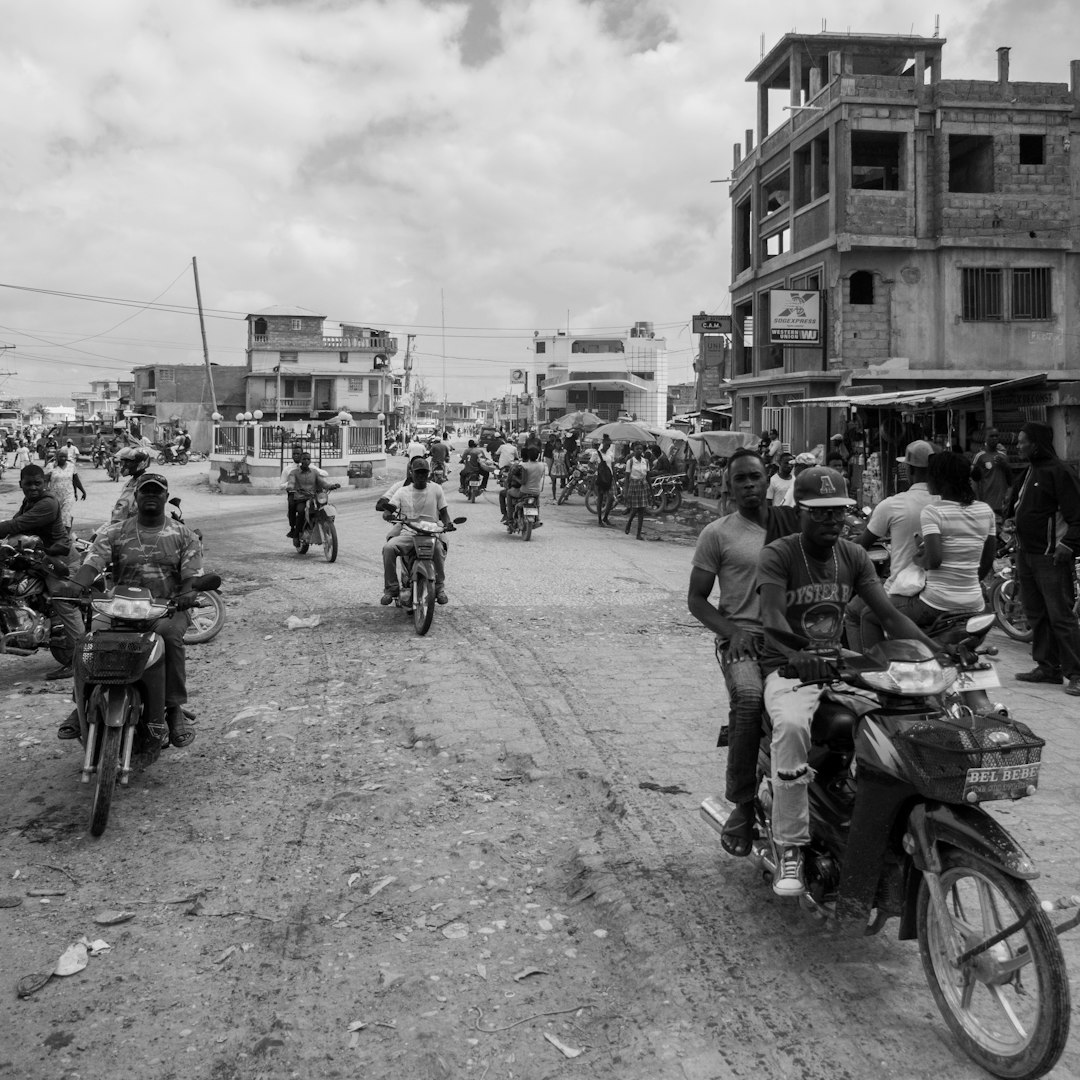 grayscale photo of people near structure