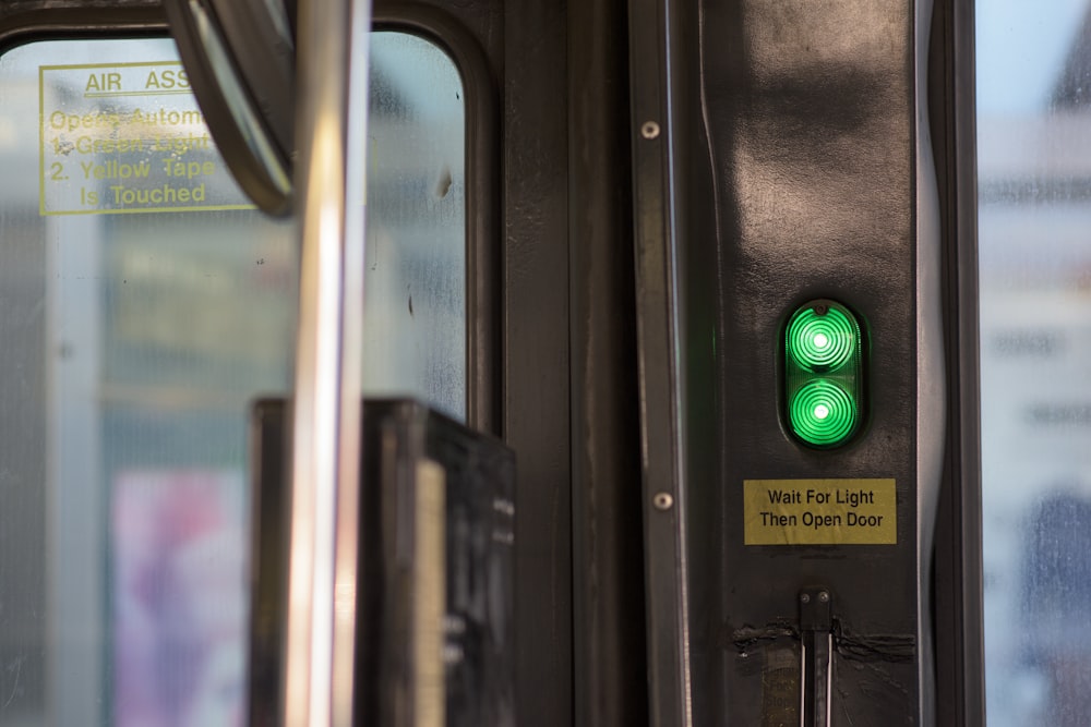 a close up of a green light on a bus