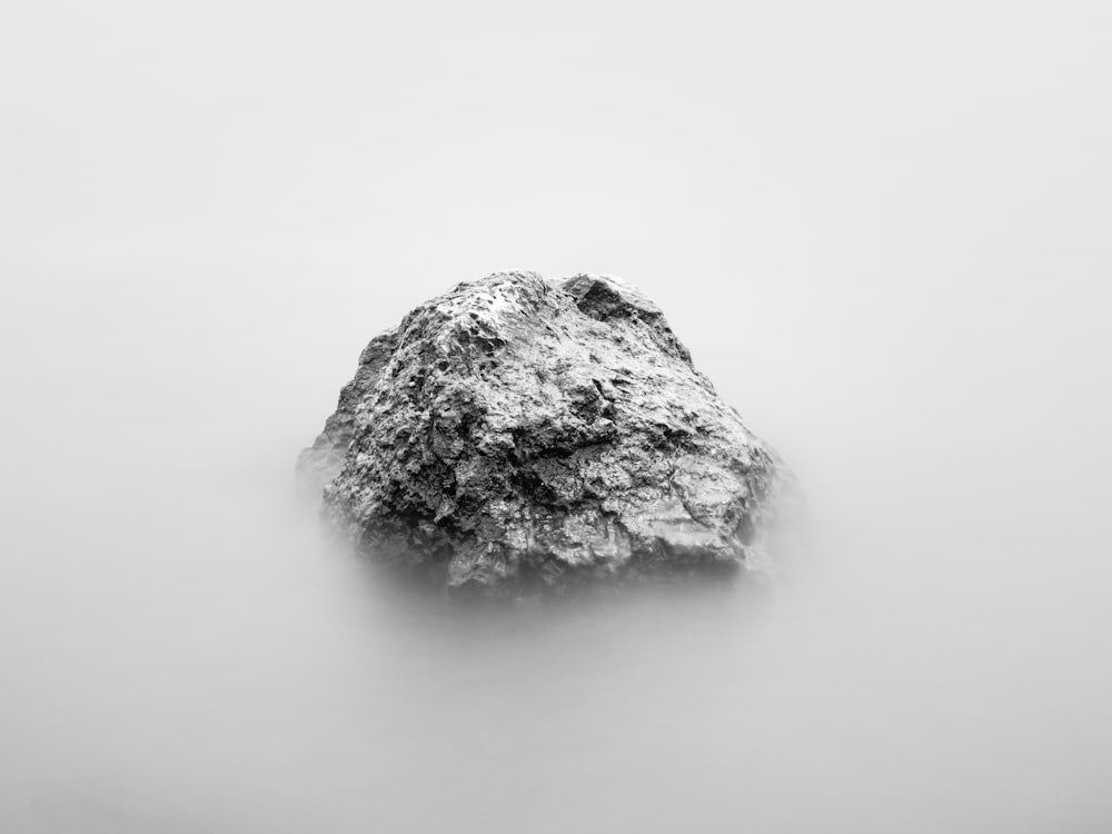 gray rock formation surrounded by clouds