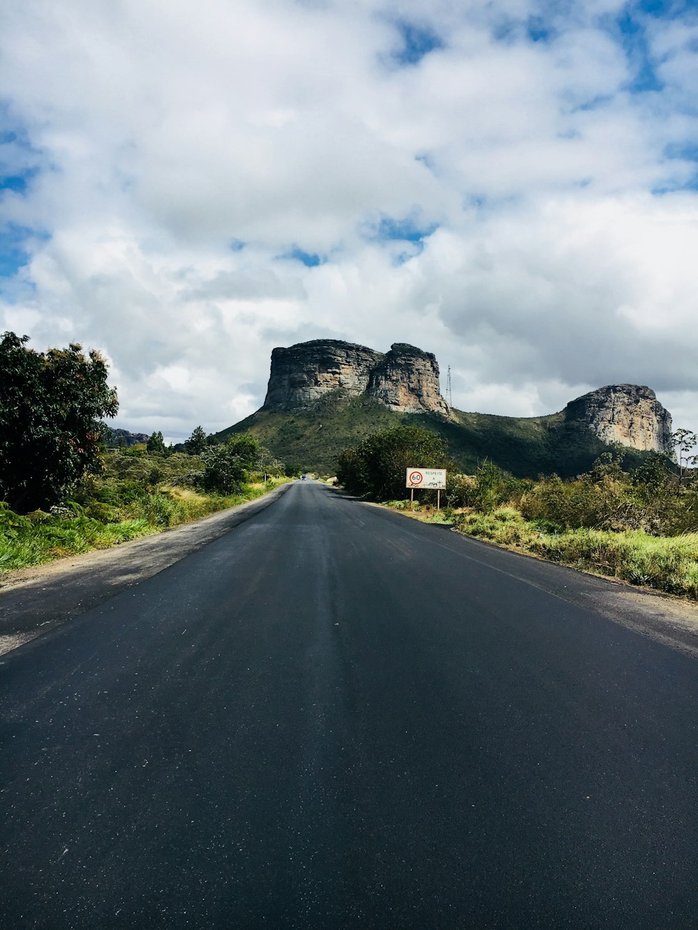 gray concrete road near mountain