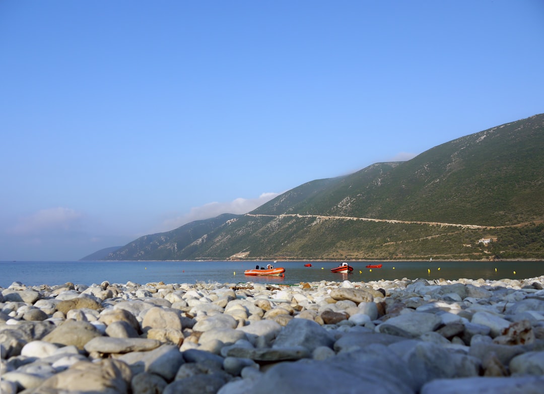 orange boat in beach during daytime