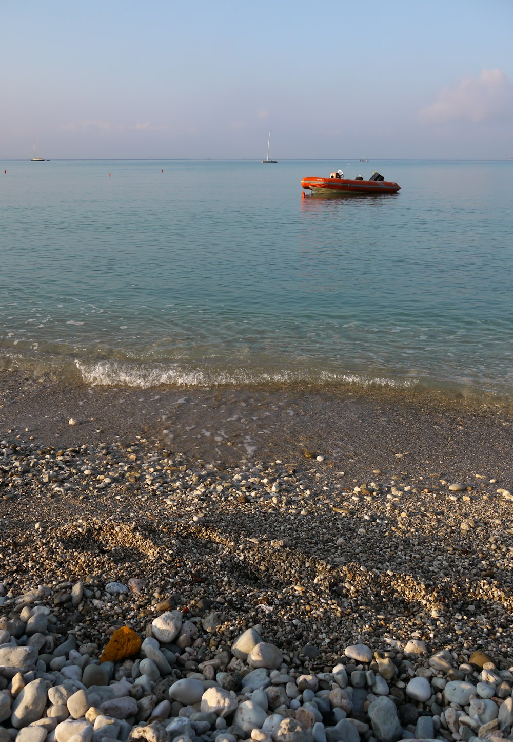 orange raft on body of water