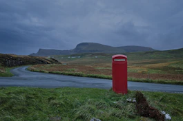 red telephone booth near road