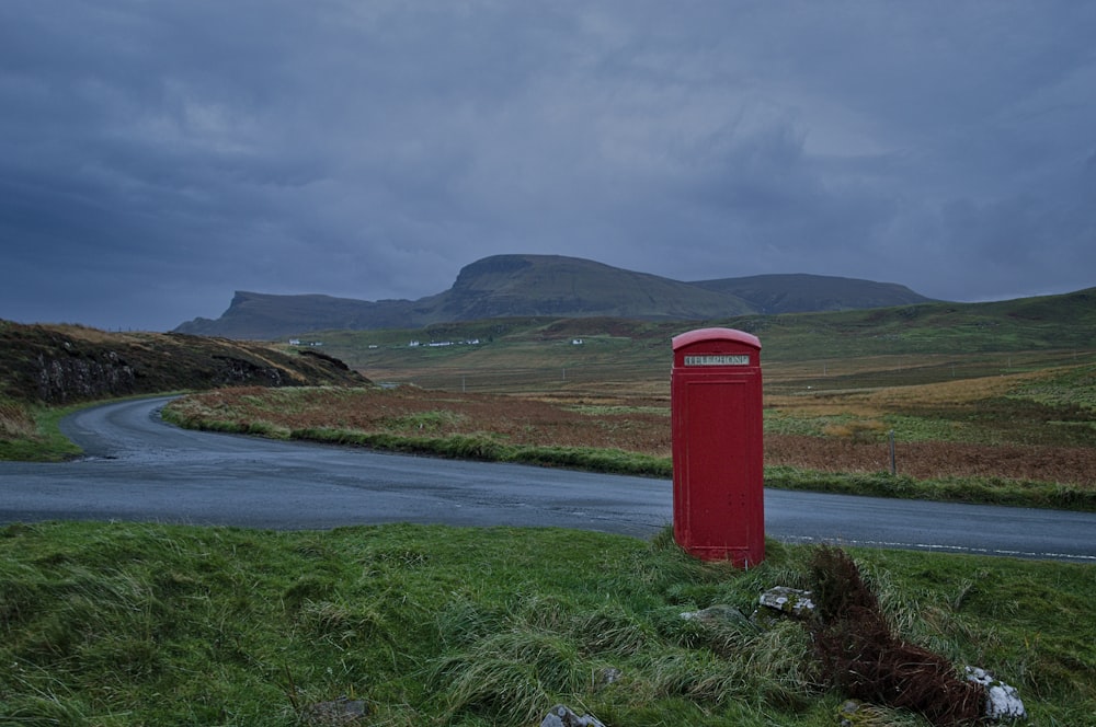 red telephone booth near road