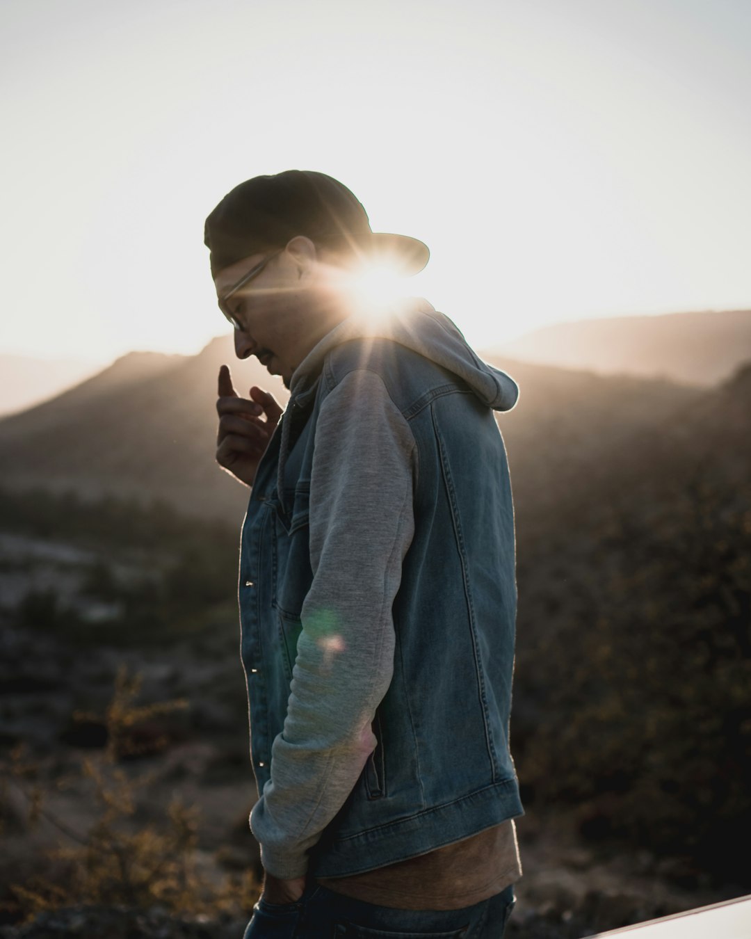 shallow focus photo of man wearing blue and gray hoodie