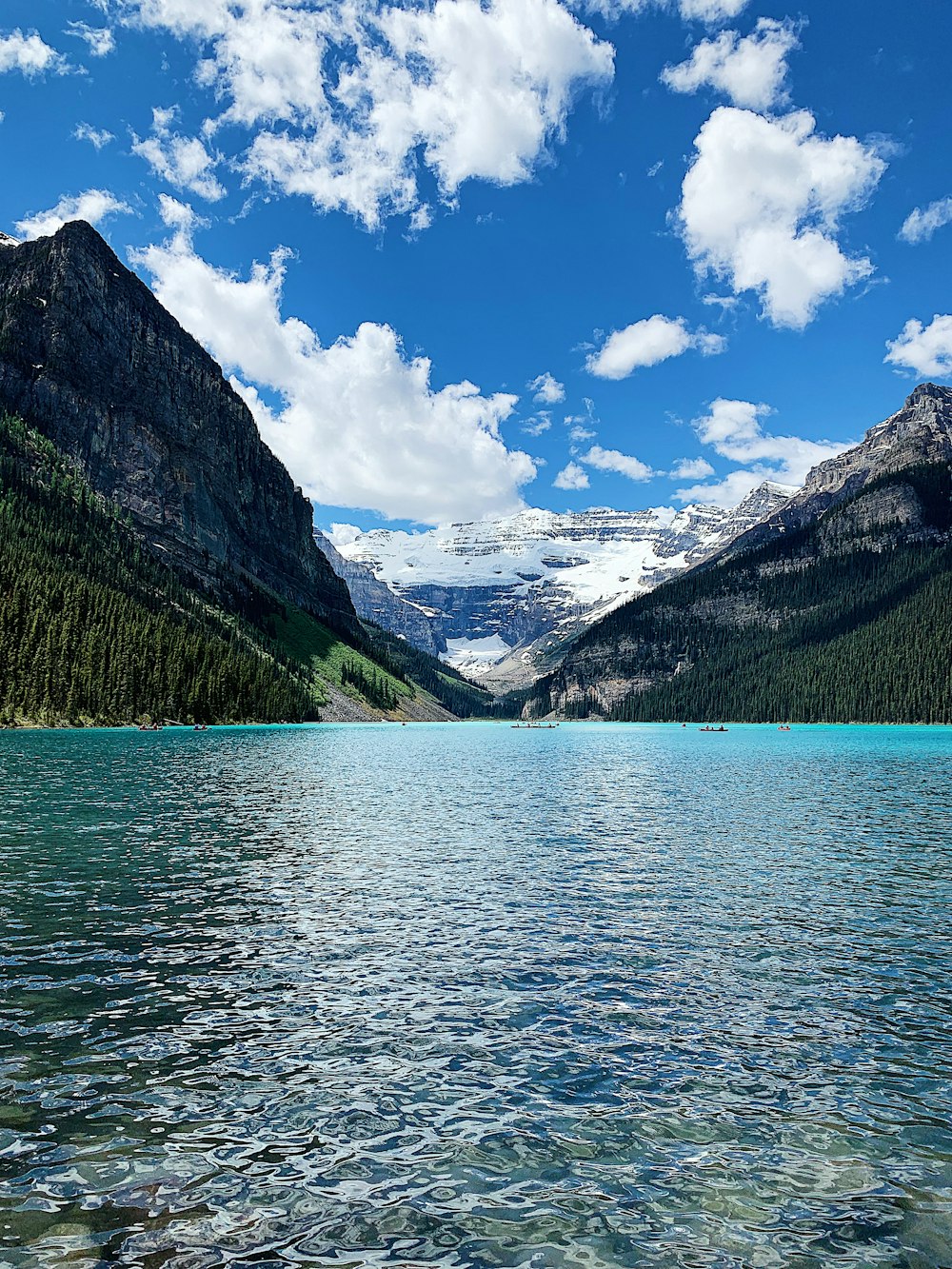 mountains and body of water under calm blue sky