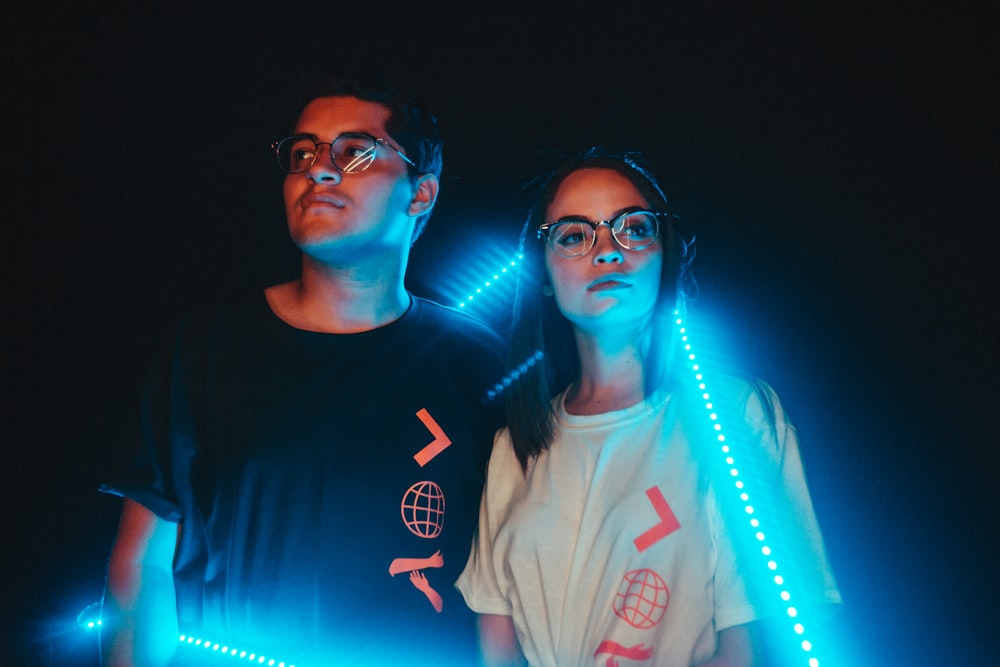couple standing near neon light