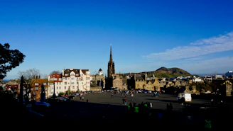 A group of travelers enjoying a scenic European city tour with historic buildings in the background.