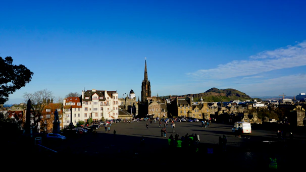 A group of travelers enjoying a scenic European city tour with historic buildings in the background.