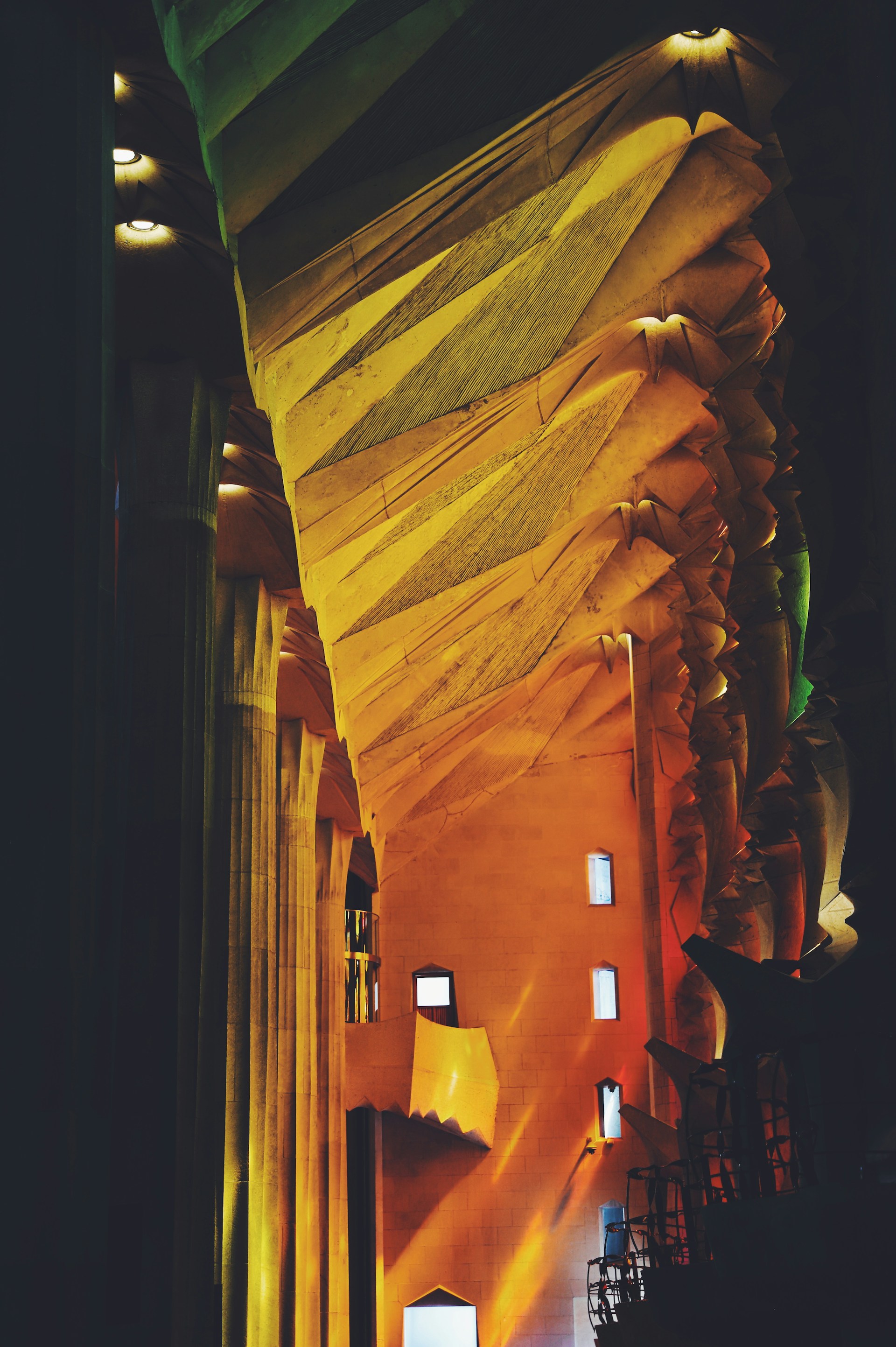 An elegant interior featuring a contemporary sculptural wall, highlighted by warm gold accents and modern lighting.